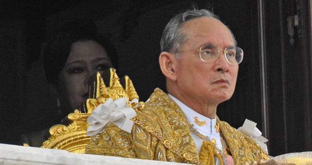 In this photo released by Thailand Public Relations Department, Thailand's King Bhumibol Adulyadej looks to hundreds of thousands of Thais gathered as Queen Sirikit waits in the shadows Friday, June 9, 2006, at Bangkok's Royal Plaza. The much-loved Thai king is celebrating his 60th anniversary on the throne and is calling for unity following months of political upheaval. (AP Photo/Thailand Public Relations Department, HO)