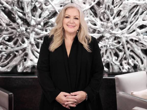 Deb McDiarmid posing for a photo in front of a white background